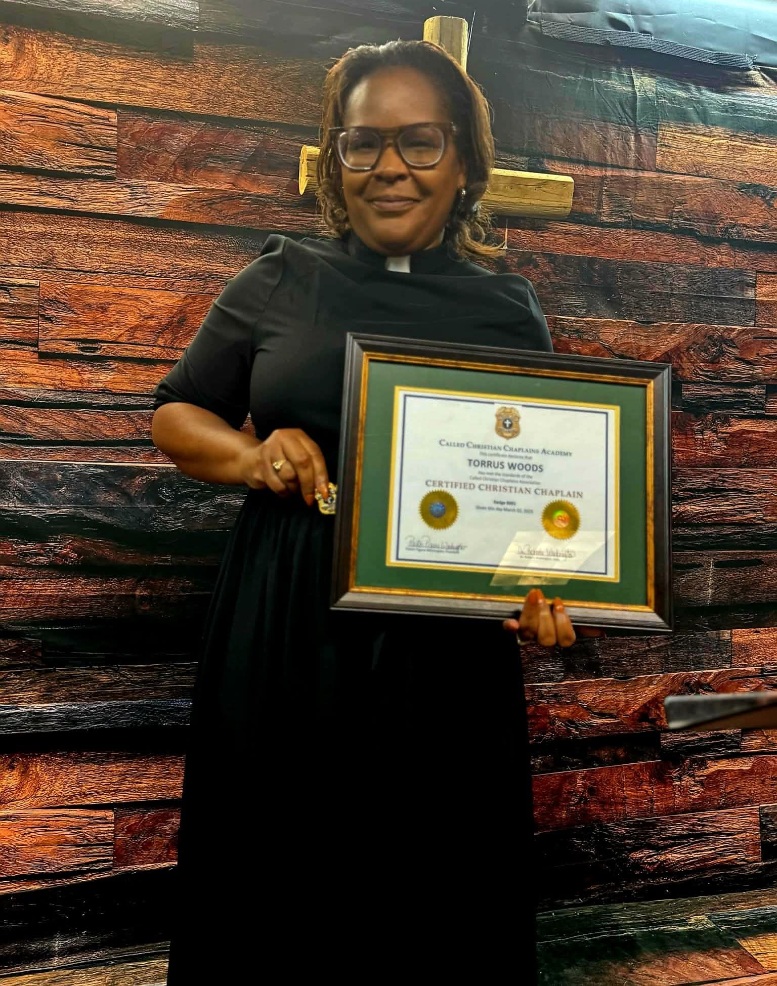 Certified Christian Chaplain Torrus Woods holding certificate