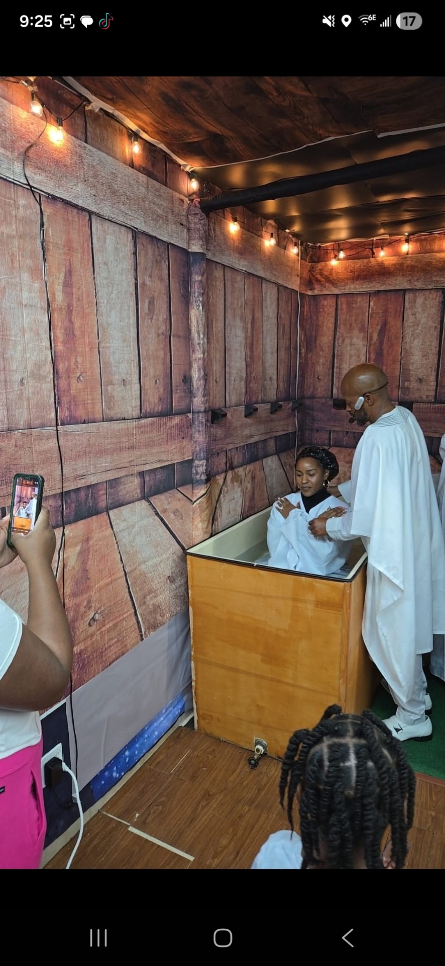 Pastor assisting candidate during baptism