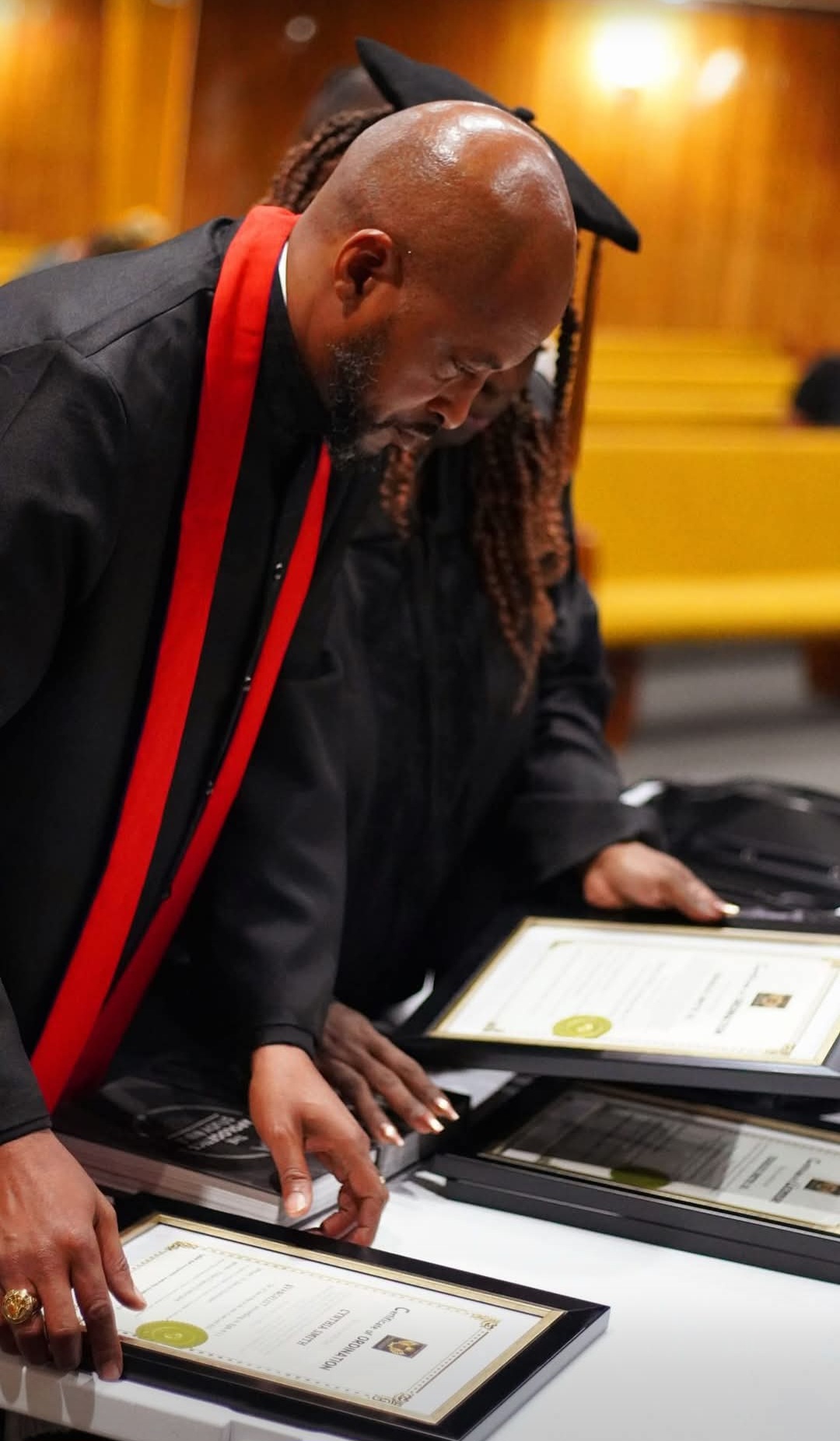 CALA graduate reviewing ordination certificates