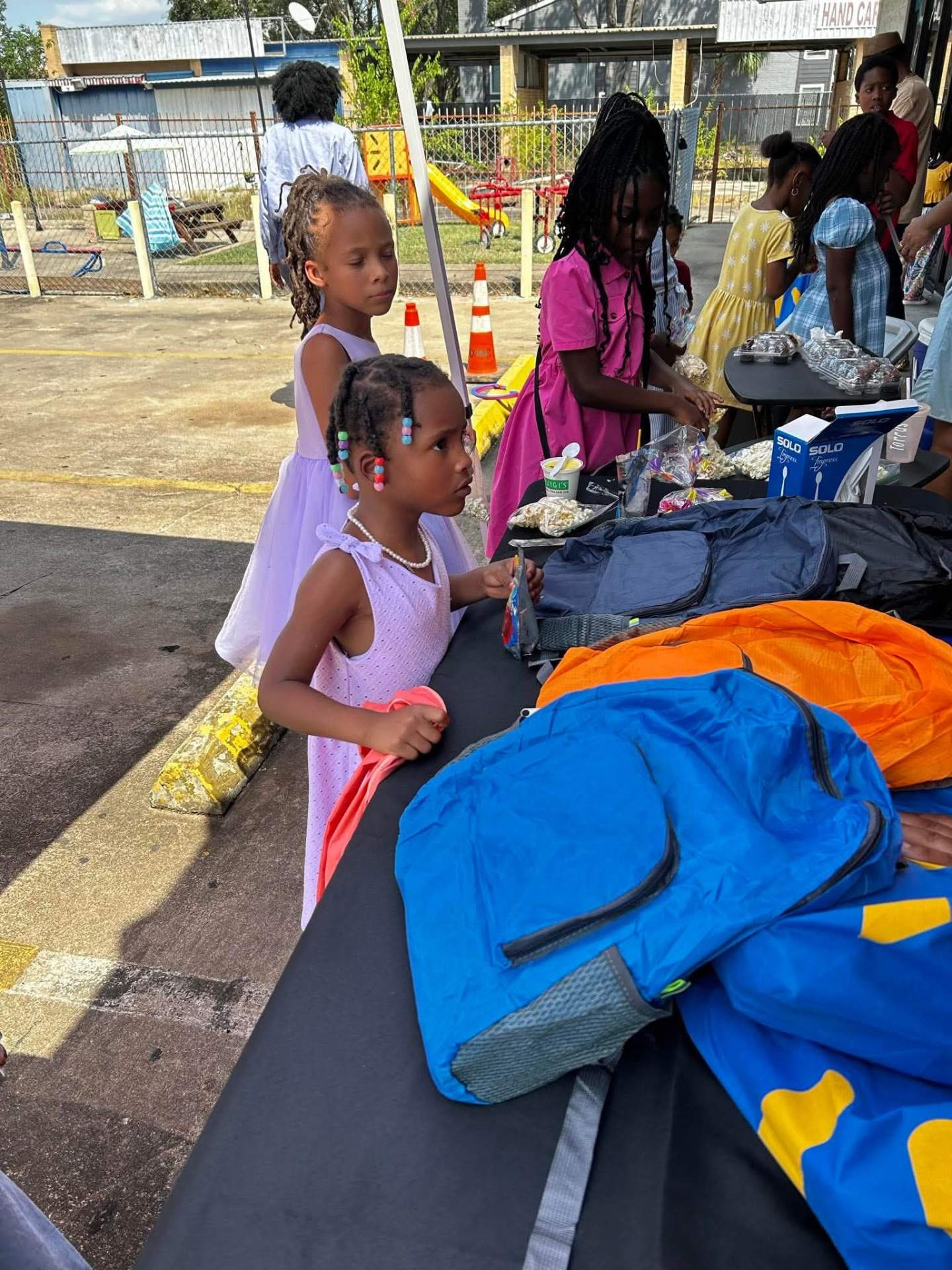 Children receiving backpacks